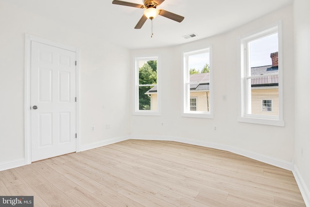 unfurnished room featuring light hardwood / wood-style floors, ceiling fan, and a healthy amount of sunlight