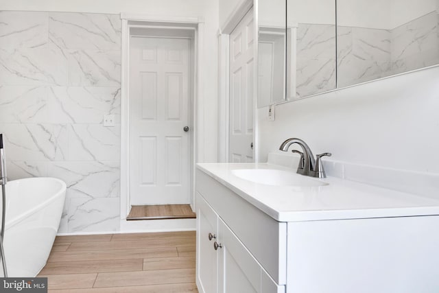 bathroom with vanity and a tub to relax in