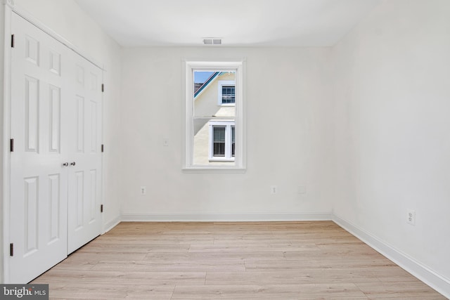 spare room with light hardwood / wood-style flooring