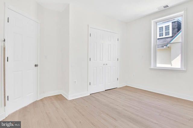 unfurnished bedroom with light wood-type flooring