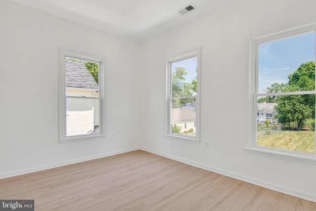 spare room featuring light hardwood / wood-style floors