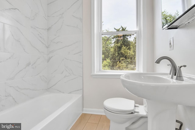 bathroom with hardwood / wood-style floors and toilet