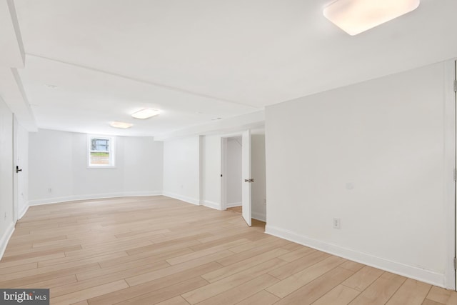 basement with light hardwood / wood-style floors