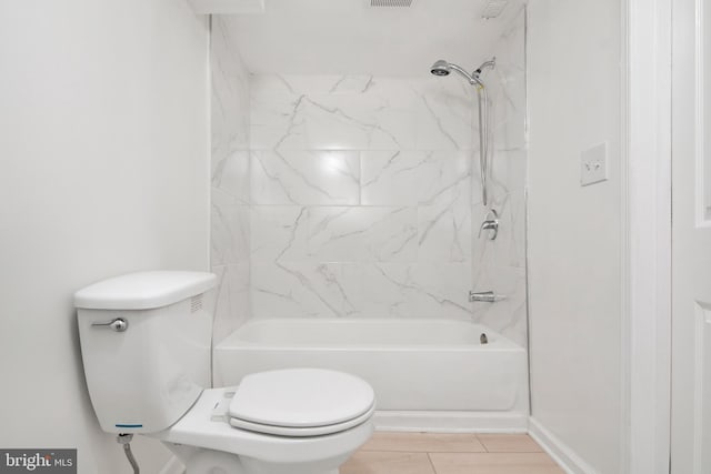 bathroom with toilet and tiled shower / bath