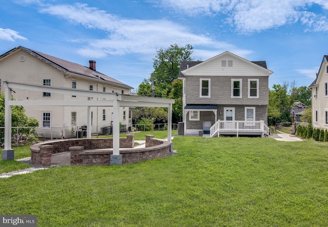 back of house featuring a lawn, cooling unit, and a deck