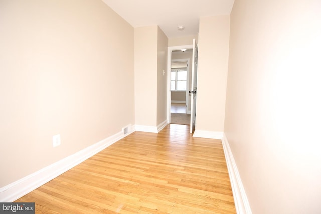 interior space with baseboards and light wood finished floors