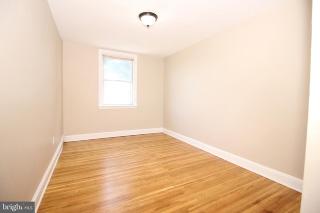 empty room featuring baseboards and light wood-style floors