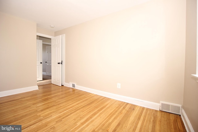 unfurnished bedroom with light wood-type flooring, visible vents, and baseboards