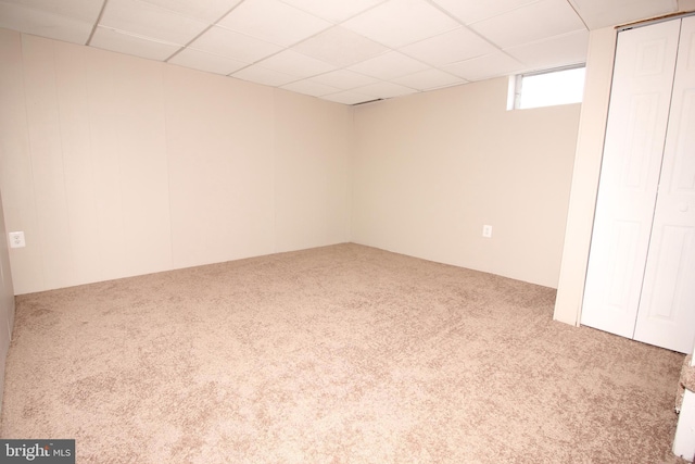 below grade area with carpet and a drop ceiling