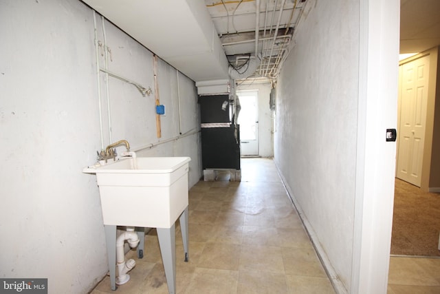 hall featuring a sink and heating unit