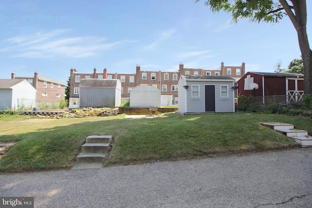 view of yard featuring a storage shed, an outdoor structure, and fence