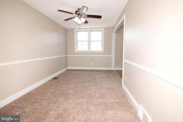 unfurnished bedroom featuring visible vents, a ceiling fan, baseboards, and carpet floors