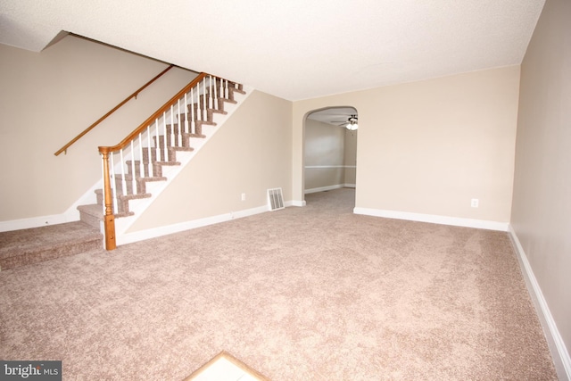 interior space featuring visible vents, arched walkways, carpet, and stairway