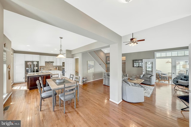 dining space featuring sink, ceiling fan, and light hardwood / wood-style flooring