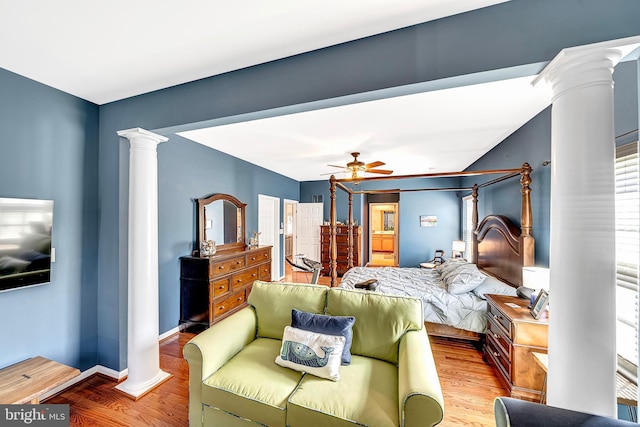 bedroom with ornate columns, ceiling fan, and wood-type flooring