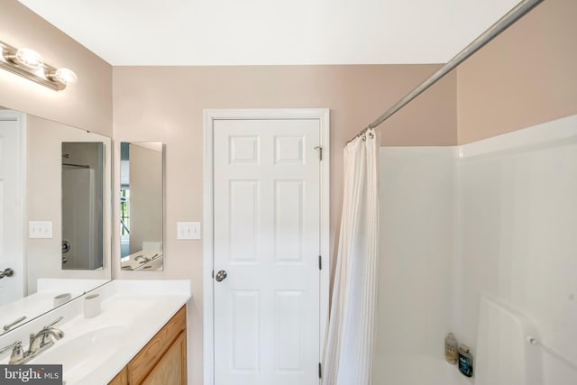 bathroom with shower / tub combo with curtain and vanity