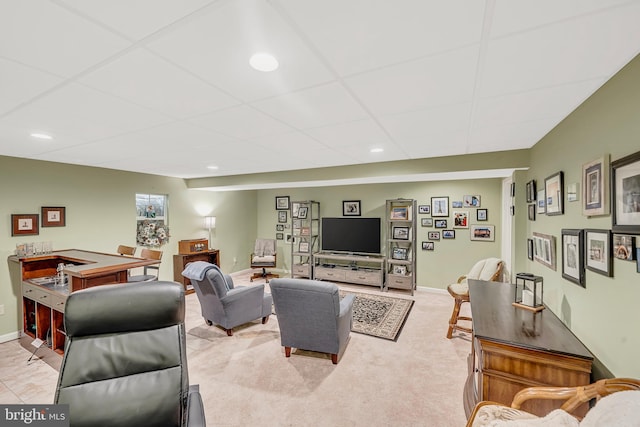 carpeted living room featuring a paneled ceiling