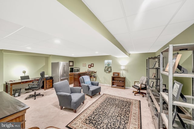 office space with a paneled ceiling and light colored carpet