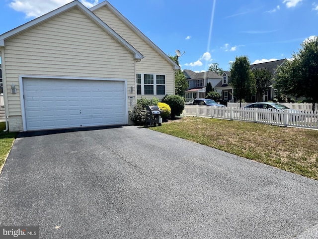 view of front facade with a front lawn and a garage