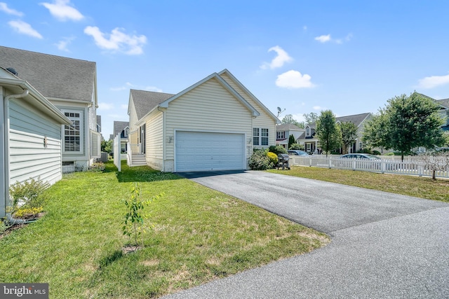 view of side of home featuring a garage and a lawn