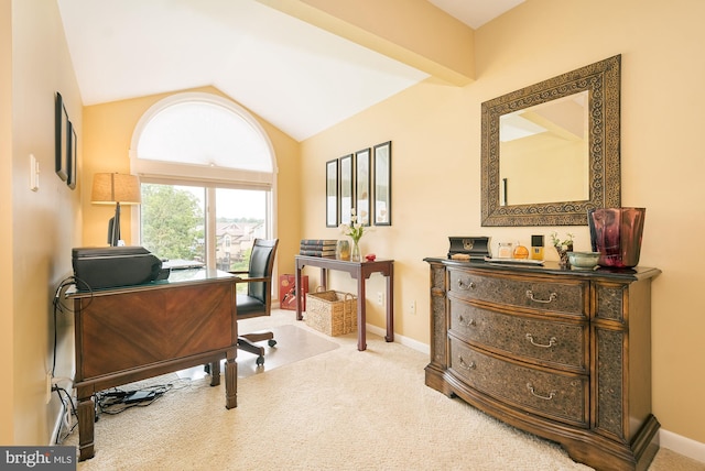 carpeted office space featuring vaulted ceiling