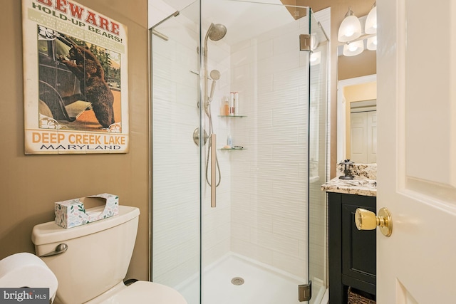 bathroom featuring vanity, toilet, and a shower with door