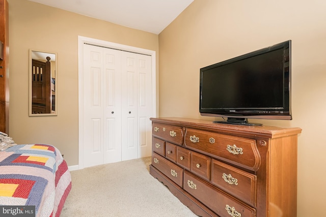 carpeted bedroom featuring a closet