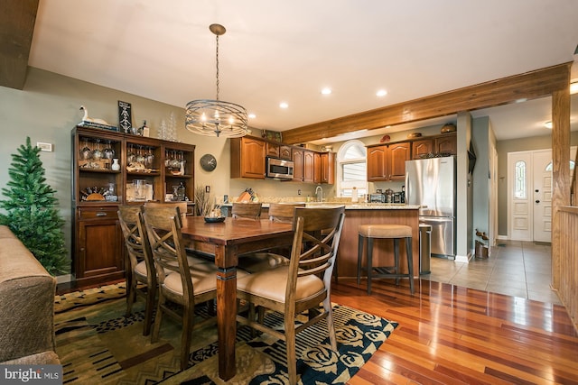 dining room featuring light hardwood / wood-style floors and a notable chandelier