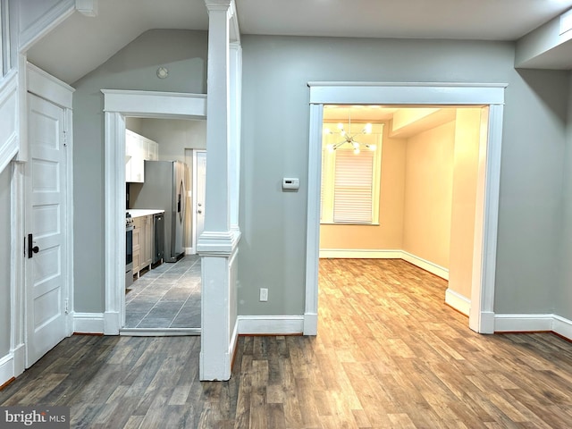 hall featuring hardwood / wood-style floors and a notable chandelier