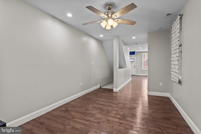 empty room featuring ceiling fan and dark hardwood / wood-style flooring