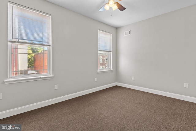 unfurnished room featuring ceiling fan, plenty of natural light, and carpet