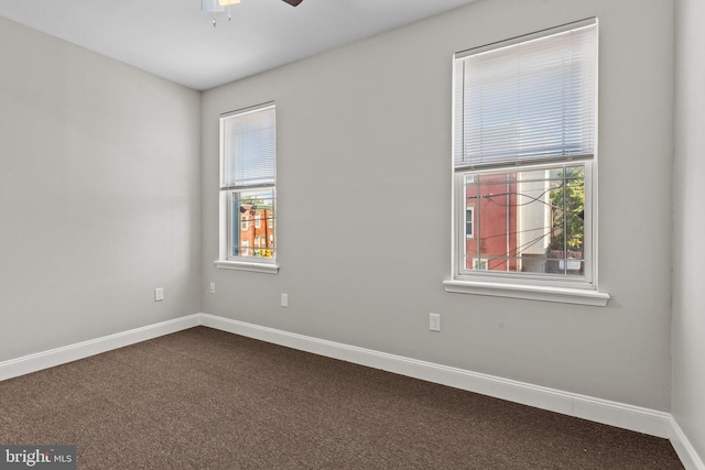 spare room featuring ceiling fan and carpet