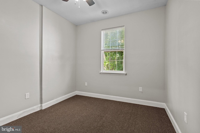 empty room featuring ceiling fan and carpet