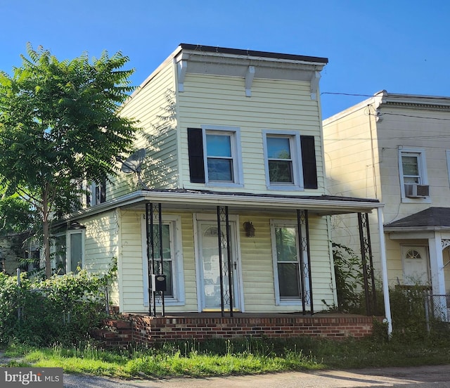 view of front of home with cooling unit and a porch