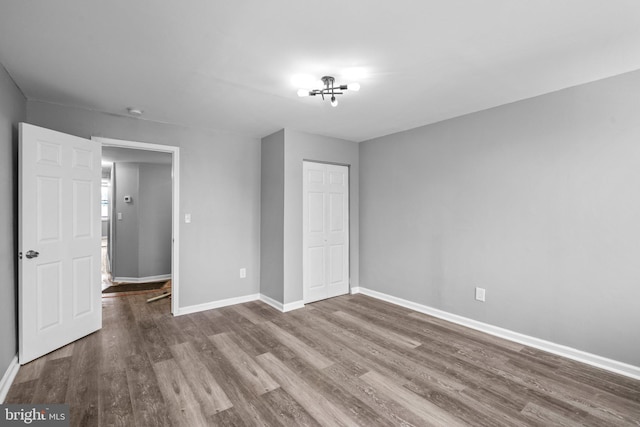 unfurnished bedroom featuring hardwood / wood-style floors and a closet