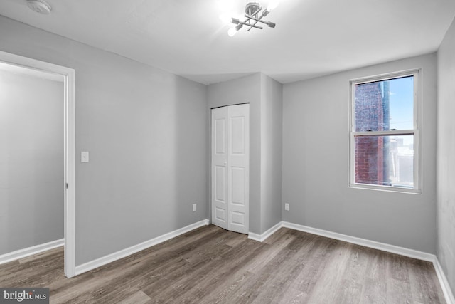 unfurnished bedroom featuring hardwood / wood-style flooring