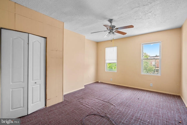 unfurnished bedroom with carpet, ceiling fan, and a textured ceiling