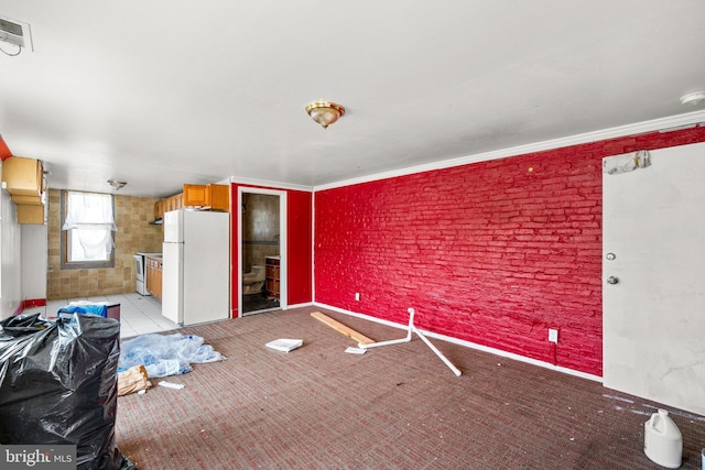 interior space featuring ensuite bathroom, ornamental molding, and white refrigerator