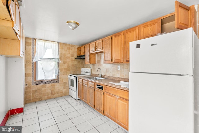 kitchen with white appliances, sink, light tile patterned floors, and tasteful backsplash