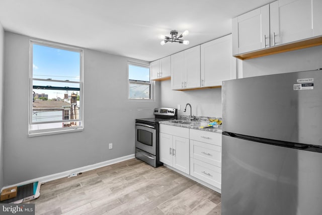 kitchen with a notable chandelier, sink, white cabinetry, and stainless steel appliances