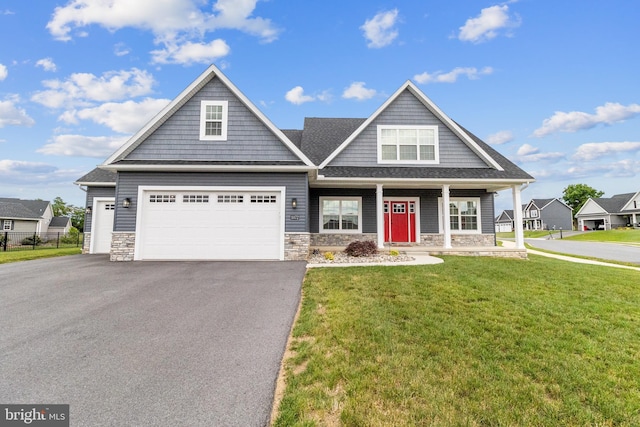 craftsman-style home with a front lawn and a garage