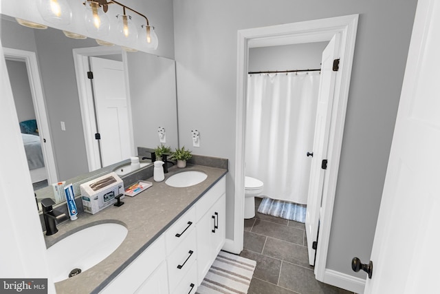 bathroom featuring toilet, vanity, and tile patterned floors