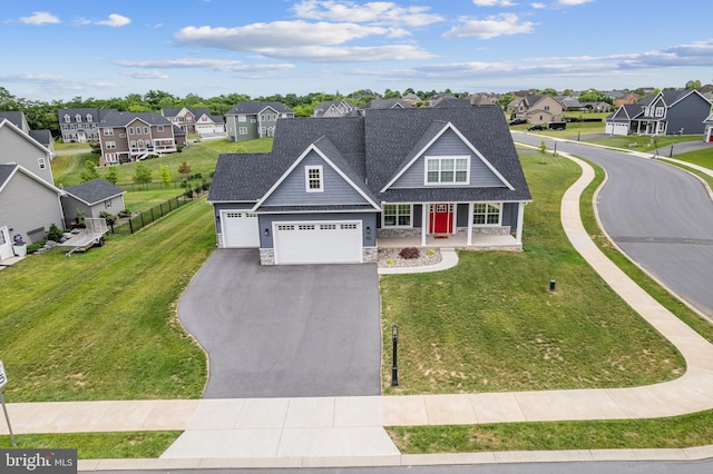 view of front of house featuring a front lawn, a porch, and a garage