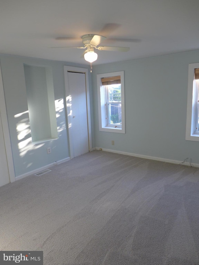 spare room featuring carpet and ceiling fan