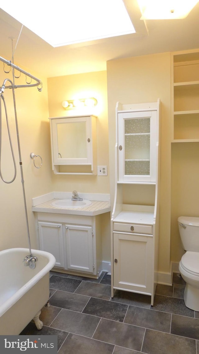 bathroom featuring a bath, vanity, and toilet