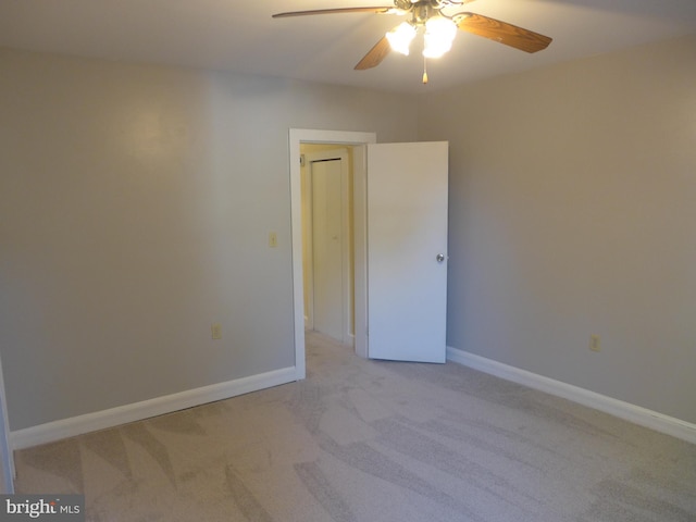 unfurnished room featuring ceiling fan and light colored carpet