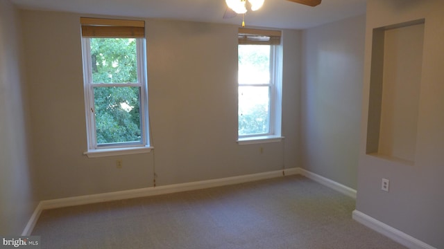 unfurnished room featuring carpet floors, plenty of natural light, and ceiling fan