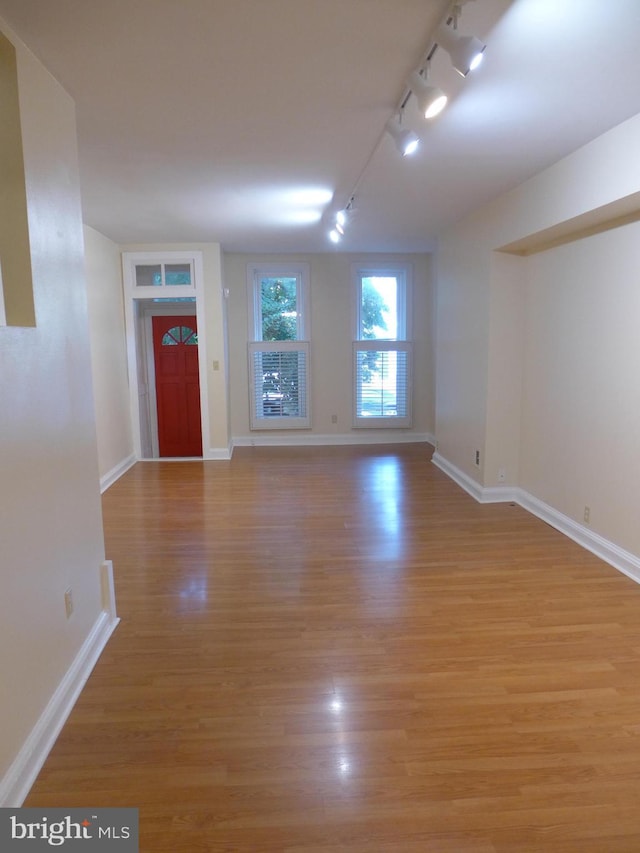 interior space featuring track lighting and light hardwood / wood-style flooring