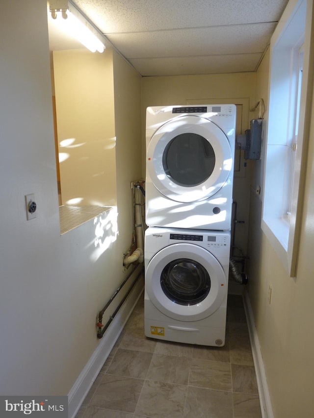 laundry room featuring stacked washer and clothes dryer