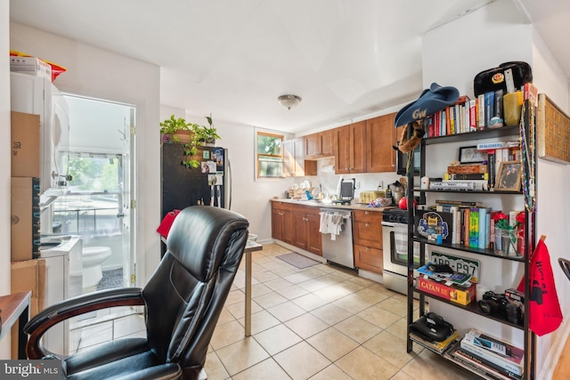 kitchen with black fridge, dishwasher, light tile patterned flooring, and gas range oven